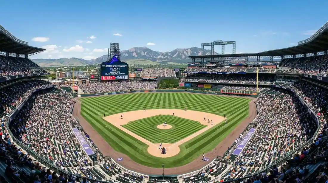 Wide-angle view of Coors Field in Denver during an MLB game with the Rocky Mountains visible beyond the outfield